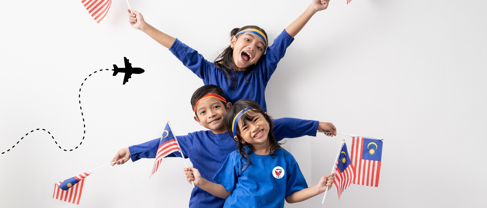 Three children in blue uniforms proudly hold up Malaysian Flag AS THEY GOT THEIR VISIT VISA FOR MALAYSIA