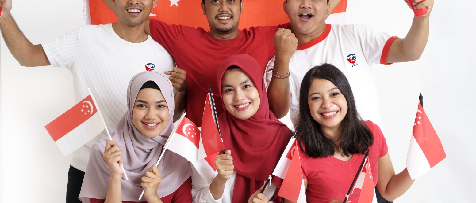 Cheerful group displaying Singapore flags with smiles as their visit visa to singapore approved